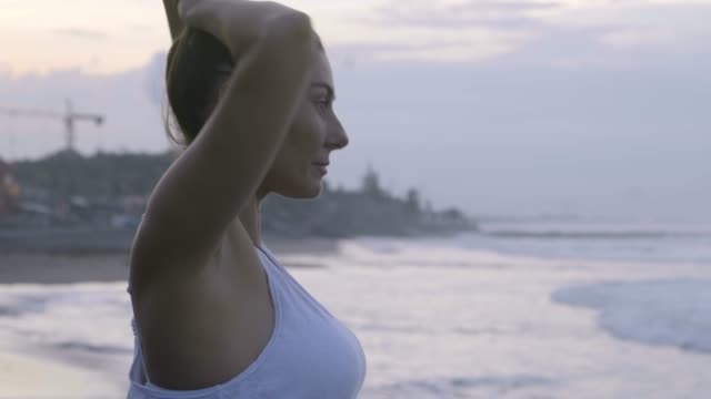 Woman-Preparing-for-Meditation-on-Beach