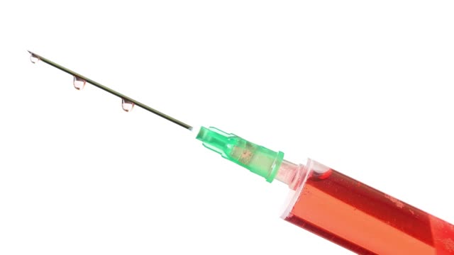 Plastic-medical-syringe-with-needle-and-drops.-Medical-injection-concept.-Medical-equipment.-4k-resolution.