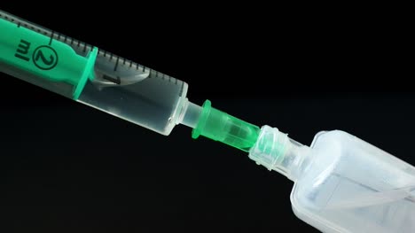 Plastic-medical-syringe-with-needle-and-plastic-vial.-Medical-injection-concept.-Medical-equipment.-4k-resolution.