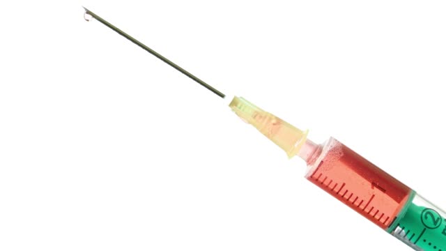 Plastic-medical-syringe-with-needle-and-drops.-Medical-injection-concept.-Medical-equipment.-4k-resolution.