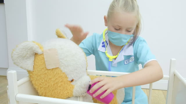 Girl-nursing-her-teddy-bear