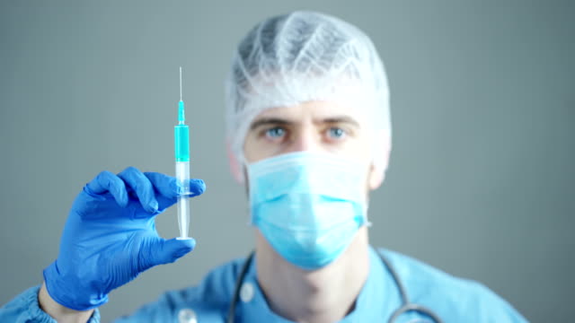 Ein-Arzt-oder-Wissenschaftler-im-Labor-hält-eine-Spritze-mit-Flüssigkeit-Impfstoffe-für-Kinder-oder-ältere-Erwachsene-oder-Heilung-von-Tierseuchen.