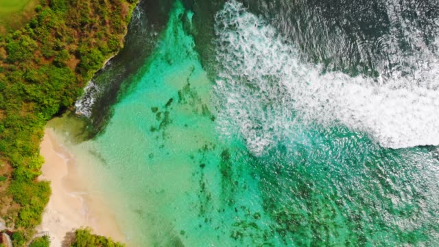 Beautiful-tropical-beach-and-turquoise-ocean-water-with-waves,-aerial-view.