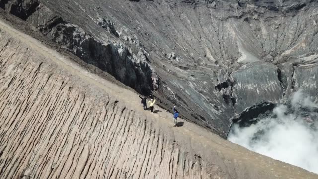 4K-Tracking-Couple-walking-by-drone-at-Crater-of-Mt.-Bromo