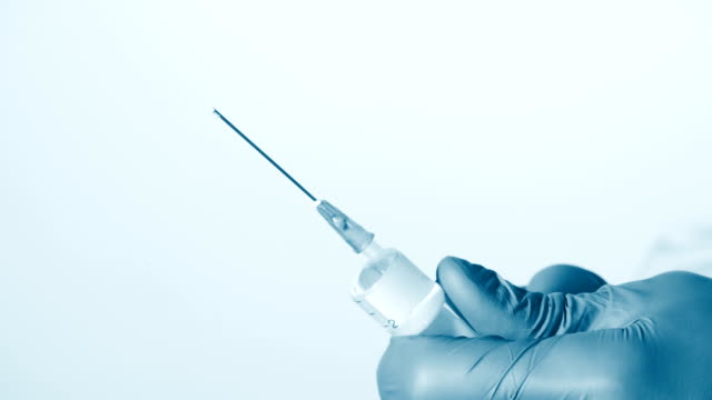 Preparing-syringe-for-giving-injection