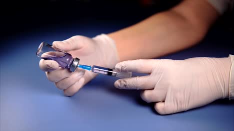 Filling-medicine-from-ampoule-into-syringe