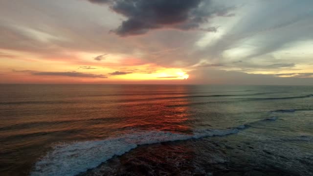 aerial-over-ocean-towards-radiant-sunset