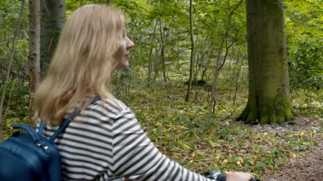 Pretty-woman-on-a-bike-ride-in-the-forest
