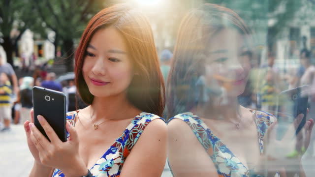 Handsome-Chinese-Woman-Texting-and-Talking-to-the-Phone-in-the-City.-Being-Happy,-Smiling-and-Having-Fun.