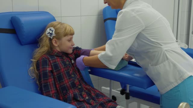 Nurse-is-taking-blood-sample-from-a-vein-in-the-arm-of-little-girl