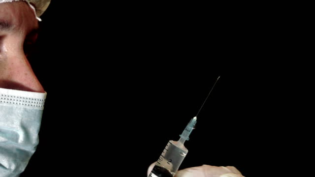 Doctor-filling-syringe.-UHD-stock-video