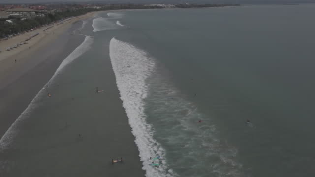 Aerial-view-waves-break-on-white-sand-beach.-Video.-Sea-waves-on-the-beautiful-beach-aerial-view.-People-in-water