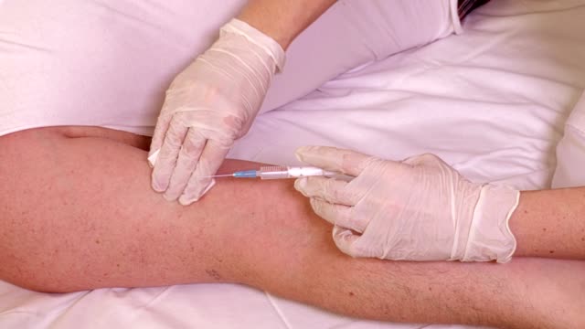 Female-doctor-with-syringe-near-patient