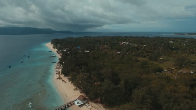 Bungalow-stay-on-tropical-island-aerial-reveal
