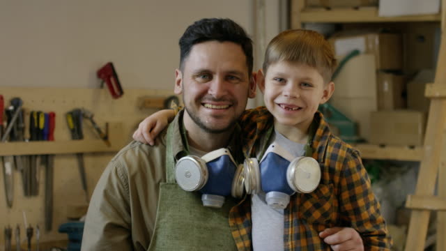 Happy-Father-and-Son-Posing-in-Workshop