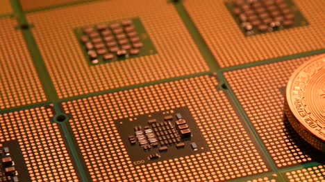 close-up-on-computer-chips-and-phisical-gold-bitcoin-with-slider.-4K-UHD-Video-Nikon-D500
