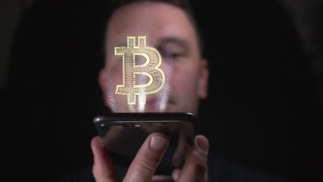 Male-opening-up-a-Bitcoin-digital-wallet-with-his-smart-phone