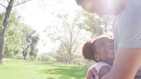 Slow-Motion-Shot-Of-Father-Hugging-Daughter-In-Park