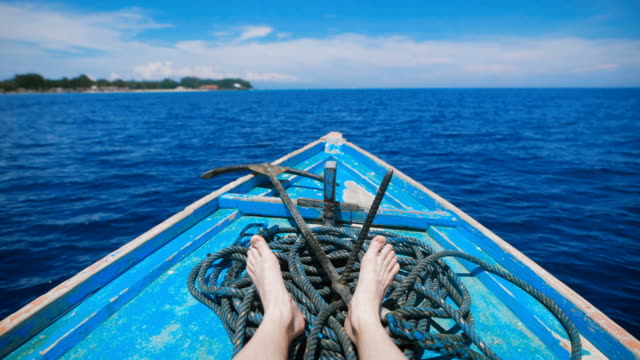 Ocean-island-of-Bali.-Boat-tour.-Young-man-in-a-boat-on-the-ocean-excursions.-Stunningly-clear-ocean,-year-round-sunshine,-paradise-island---idyllic-picture