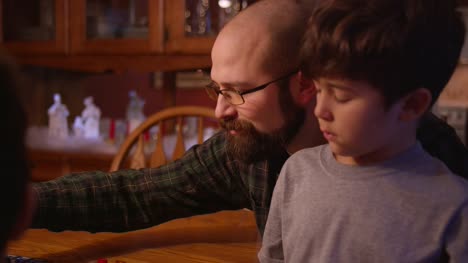 A-father-and-son-playing-a-board-game-together-at-home
