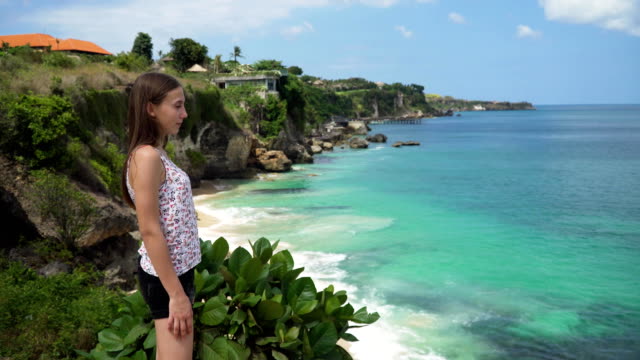 Mädchen-stehen-auf-einer-Klippe-mit-Blick-auf-das-Meer.-Bali,-Indonesien