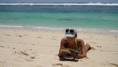 Girl-on-the-beach-reading-a-book