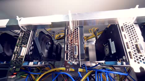 Motion-footage-of-bitcoin-mining-process-held-by-a-row-of-graphic-processing-units