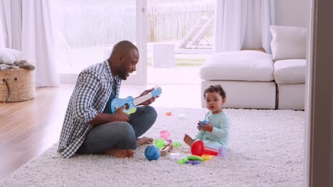Young-black-father-singing-to-his-young-son-in-sitting-room
