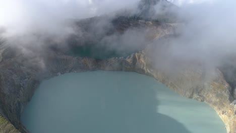 Kelimutu-tri-coloured-volcano-crater-covered-with-mist-an-aerial-view-early-morning