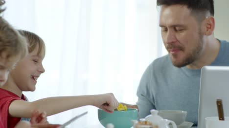 Little-Girl-Feeding-Father-and-Laughing