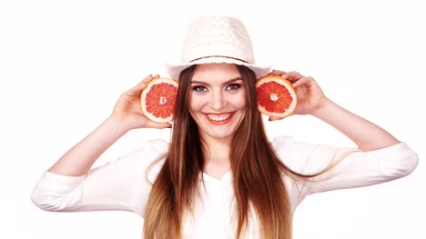 Woman-holds-two-halfs-of-grapefruit-citrus-fruit-in-hands-4K