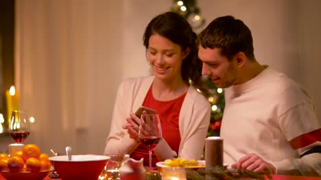 couple-taking-selfie-at-home-christmas-dinner