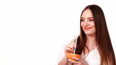Woman-holds-grapefruit-drinking-juice-from-fruit-4K