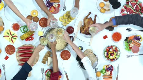 Top-view-of-dinner-on-table-together.-People-enjoy-eating-and-drinking-in-party.-Concept-of-festival,-birthday,-happy-new-year-and-christmas.-4k-resolution.