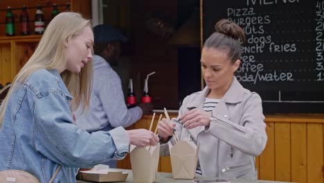 Caucasian-girls-trying-street-food