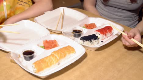 Japanese-food.-A-woman-eats-rolls,-delivered-to-the-house