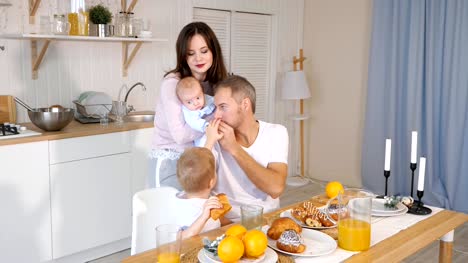 happy-mother,-father-and-son-having-breakfast-at-home