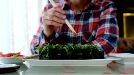 young-man-eating-sushi-in-a-Japanese-restaurant