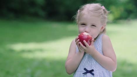 Healthy-Nutrition.-Child-Eating-Juicy-Apple-Outdoors