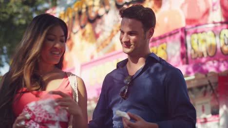 A-couple-eating-cotton-candy-at-a-fair