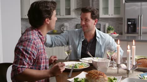 Male-gay-couple-having-a-candlelit-dinner-in-their-kitchen,-shot-on-R3D