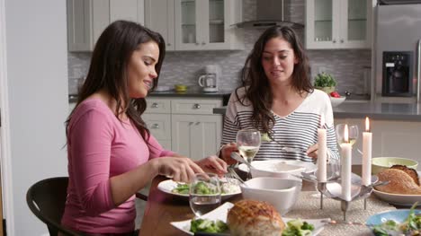 Female-gay-couple-make-a-toast-at-dinner-in-their-kitchen,-shot-on-R3D