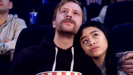 Man-embraces-his-girlfriend-at-the-movie-theater