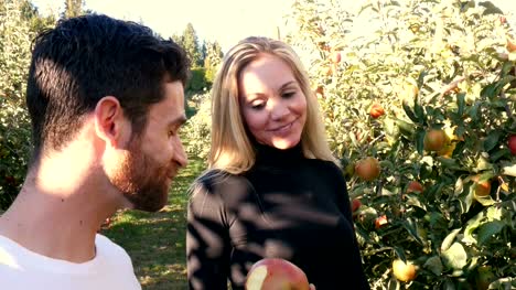 Man-eating-apple-in-apple-orchard