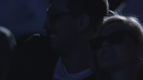 Close-up-footage-of-a-couple-embrace-each-other-while-having-fun-watching-5d-film-screening-in-cinema.