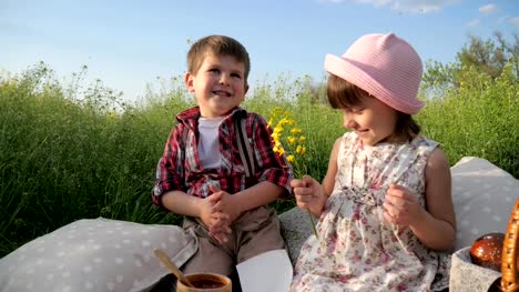 boy-is-looking-at-beautiful-girl,-closeup-portrait,-boy-is-giving-flowers-to-pretty-girl,-young-couple-in-love,-two-adorable-children