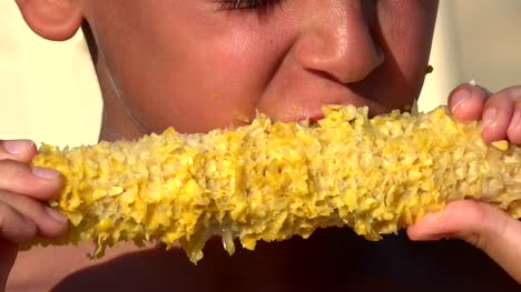 Hungry-refugee-boy-eating-corn-on-the-cob