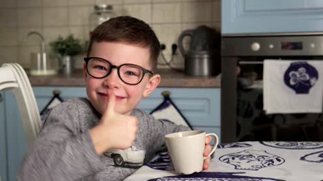 Little-boy-is-drinking-milk-and-showing-thumbs-up
