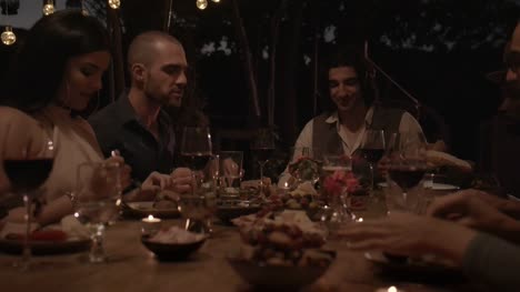 Young-multi-ethnic-friends-and-couples-celebrating-at-elegant-dinner-party