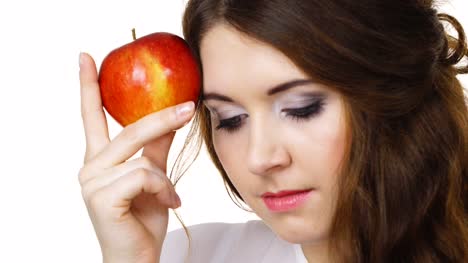 Woman-holds-apple-fruit-close-to-face,-isolated